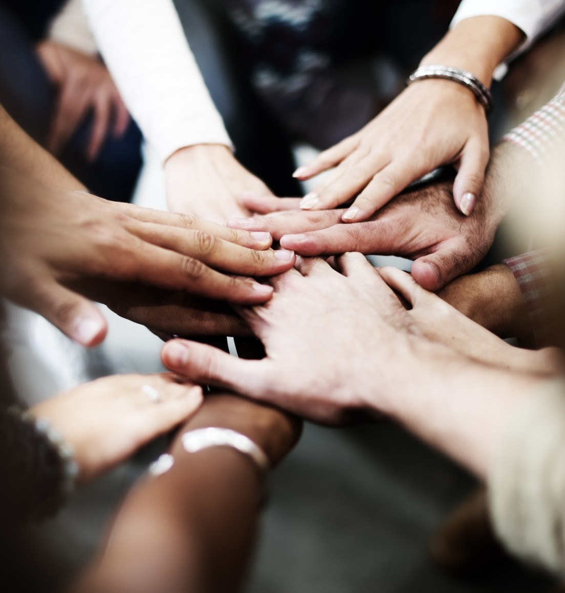 hands placed in a pile representing teamwork